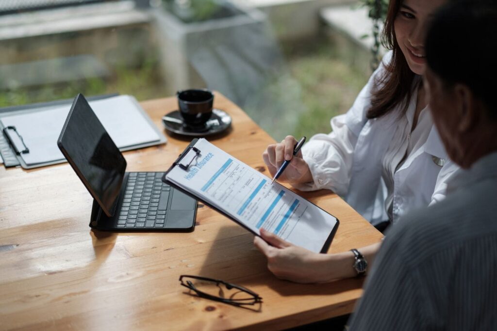 Insurance agent quoting a customer with a Vonix VoIP phone on her desk