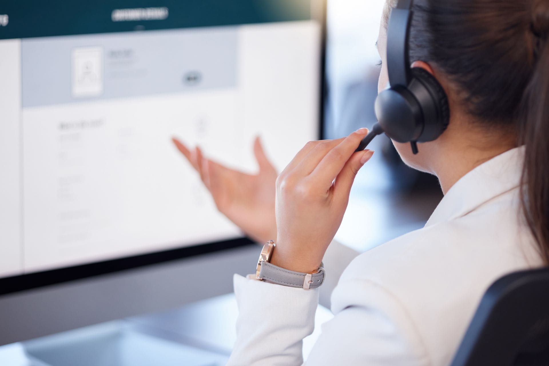 A business professional using a secure fixed VoIP phone system at their desk.
